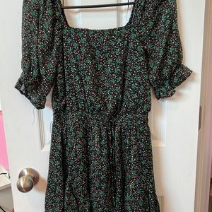 A green, gold pink flower printed dress with a black base